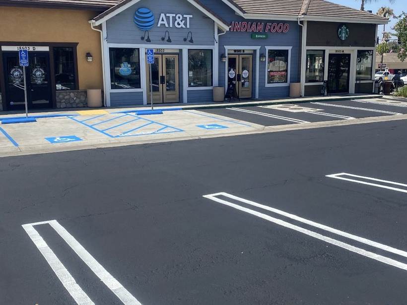 Multi-tenant retail plaza with fresh striping and accessible stalls
