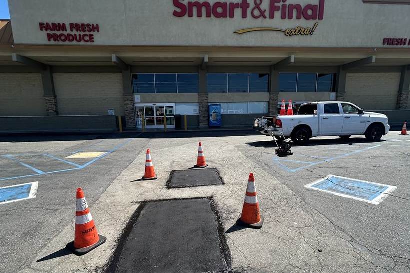 Saw-cut asphalt patch repair completed in a grocery store lot